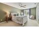 This bedroom includes a ceiling fan and has access to the screened in porch at 18914 Geraci Rd, Lutz, FL 33548