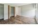 This bedroom has wood-look floors, light paint, and a closet at 18914 Geraci Rd, Lutz, FL 33548