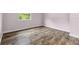 This bedroom features wood-look flooring and a large window bringing in natural light at 18914 Geraci Rd, Lutz, FL 33548