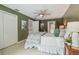 This bedroom includes a ceiling fan and has a decorative plant in the corner at 18914 Geraci Rd, Lutz, FL 33548
