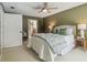 The bedroom includes a ceiling fan and has an ensuite bathroom at 18914 Geraci Rd, Lutz, FL 33548