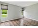 This bedroom features wood-look flooring and large windows bringing in natural light at 18914 Geraci Rd, Lutz, FL 33548