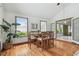 Cozy dining room featuring wood floors, a large window, and a traditional dining set at 18914 Geraci Rd, Lutz, FL 33548