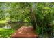 Waterfront dock with lush tree cover, offering a serene spot to enjoy nature at 18914 Geraci Rd, Lutz, FL 33548