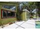 Exterior view of the screened-in porch and a spiral staircase that leads to the deck above at 18914 Geraci Rd, Lutz, FL 33548