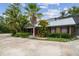 Charming home with lush landscaping, mature palms, and a welcoming front entrance at 18914 Geraci Rd, Lutz, FL 33548