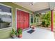 Inviting front entryway with double doors, potted plants, and a welcoming ambiance at 18914 Geraci Rd, Lutz, FL 33548