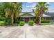 Charming home with lush landscaping, mature palms, and a welcoming front entrance at 18914 Geraci Rd, Lutz, FL 33548
