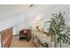 Bright hallway featuring a cozy chair, console table, and tasteful decor at 18914 Geraci Rd, Lutz, FL 33548