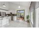 Modern kitchen with stainless steel appliances opening to breakfast area at 18914 Geraci Rd, Lutz, FL 33548