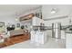 Spacious kitchen with white cabinets, stainless steel appliances, and breakfast bar at 18914 Geraci Rd, Lutz, FL 33548