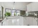 Open kitchen with granite countertops overlooking a sunny breakfast nook at 18914 Geraci Rd, Lutz, FL 33548