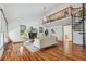 Bright living room features hardwood floors, a fireplace, soaring ceilings, and a spiral staircase at 18914 Geraci Rd, Lutz, FL 33548