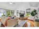 Bright living room featuring wood floors, fireplace, and large windows with natural light at 18914 Geraci Rd, Lutz, FL 33548