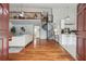 Open-concept living area with gleaming hardwood floors, spiral staircase, and ample natural light at 18914 Geraci Rd, Lutz, FL 33548