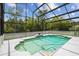 Screened-in pool with a lovely waterfall feature, tile surround, and meticulously maintained space at 18914 Geraci Rd, Lutz, FL 33548