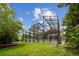 A screened pool with a green lawn is featured in this exterior home image at 18914 Geraci Rd, Lutz, FL 33548