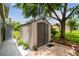 The backyard features a shed set upon a patio area with a variety of potted plants at 18914 Geraci Rd, Lutz, FL 33548