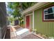 The rear of the house features a green shed with a red door and small potted plants at 18914 Geraci Rd, Lutz, FL 33548