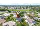 An aerial view of a home in a residential community that is marked with a red arrow at 205 Wimbly Pl, Sun City Center, FL 33573
