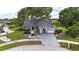 Aerial view of a cozy one-story home on a well-manicured lot with mature landscaping at 205 Wimbly Pl, Sun City Center, FL 33573