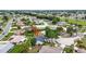 Aerial view of house with a red arrow on a landscaped property in a residential neighborhood at 205 Wimbly Pl, Sun City Center, FL 33573