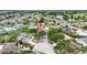 Community aerial view of home near golf course and lake highlighted with a red arrow at 205 Wimbly Pl, Sun City Center, FL 33573