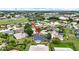 Neighborhood real estate aerial view featuring nearby roads, buildings, and a red arrow at 205 Wimbly Pl, Sun City Center, FL 33573