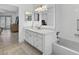 Bathroom featuring a shower-tub combo, white vanity, and tiled flooring at 205 Wimbly Pl, Sun City Center, FL 33573