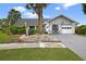Charming single-story home featuring an attached garage, well-manicured landscaping, and a welcoming front entrance at 205 Wimbly Pl, Sun City Center, FL 33573