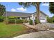 Charming single-story home showcasing lush landscaping, mature trees, and a classic residential appeal at 205 Wimbly Pl, Sun City Center, FL 33573