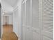 Hallway features hardwood floors, access to closet and bedrooms, and natural light at 205 Wimbly Pl, Sun City Center, FL 33573