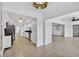 Bright kitchen with white cabinets and stainless steel appliances leading into the living space at 205 Wimbly Pl, Sun City Center, FL 33573