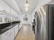 Modern kitchen with stainless steel appliances, sleek countertops, and white cabinetry at 205 Wimbly Pl, Sun City Center, FL 33573