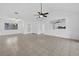 Living room featuring tile floors, ceiling fan, access to kitchen and dining room at 205 Wimbly Pl, Sun City Center, FL 33573