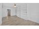 The bright living room is complemented by built-in bookshelves and views of the entryway at 205 Wimbly Pl, Sun City Center, FL 33573