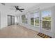 Sunroom with tile floors, a ceiling fan, and views of the backyard at 205 Wimbly Pl, Sun City Center, FL 33573