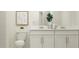 Bright bathroom featuring white cabinets, modern fixtures, and stylish decor at 210 Se 27Th St, Ruskin, FL 33570
