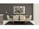 Modern dining room features a sleek wooden table and decorative black-and-white artwork at 210 Se 27Th St, Ruskin, FL 33570