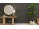 Hallway featuring a modern wooden table, round mirror, and decorative lamp near a green plant at 210 Se 27Th St, Ruskin, FL 33570