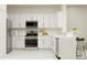 Bright kitchen with white cabinets, stainless steel appliances, and modern fixtures at 210 Se 27Th St, Ruskin, FL 33570