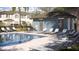 Community pool featuring a bath house, lounge chairs, and nearby townhomes at 210 Se 27Th St, Ruskin, FL 33570