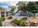 Spacious backyard with a storage shed, playset, and multiple raised garden beds at 2135 Pocahontas Dr, Largo, FL 33774