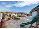 Charming backyard featuring a playset, gravel, shed, and well-maintained raised garden beds at 2135 Pocahontas Dr, Largo, FL 33774