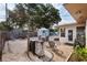 Backyard view showcasing outdoor furniture, a grill, and a storage shed amidst lush greenery at 2135 Pocahontas Dr, Largo, FL 33774
