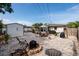 Backyard view featuring an outdoor dining area, fire pit, storage shed, and grills at 2135 Pocahontas Dr, Largo, FL 33774