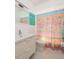 Bathroom featuring a white vanity, toilet, mirror, and a vibrant patterned shower curtain at 2135 Pocahontas Dr, Largo, FL 33774