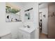 Clean bathroom with a white vanity, mirror, and a view to the outside from the window at 2135 Pocahontas Dr, Largo, FL 33774