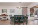 Cozy dining area with a rustic wooden table, colorful chairs, and a modern light fixture at 2135 Pocahontas Dr, Largo, FL 33774