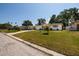 Charming single-story home with a lush green lawn and an American flag on display at 2135 Pocahontas Dr, Largo, FL 33774